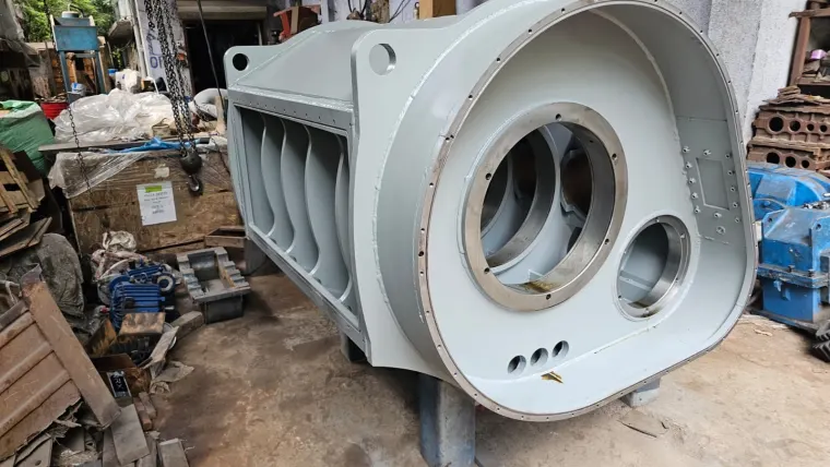 Fabricated housing with a large rectangular side opening and the flanged bore openings on its end face