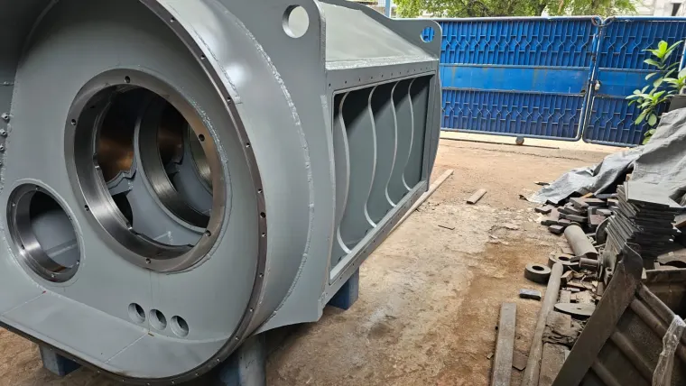 Side opening of the fabricated housing showing curved welded internal ribs, with machined bore openings on the end face