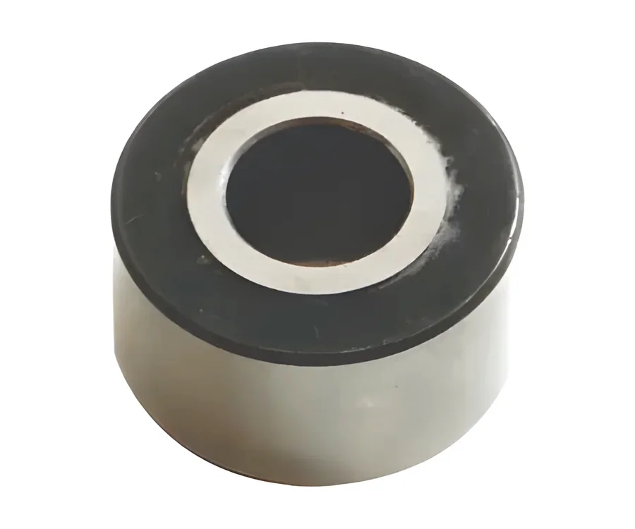 Cylindrical bushing with a steel ring around a dark bore